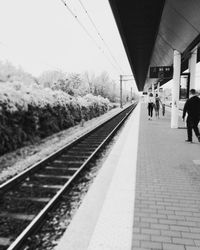 People walking on railroad station platform