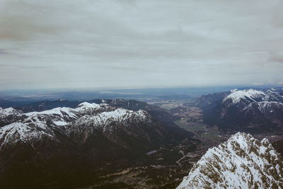 Aerial view of snowcapped mountains against sky