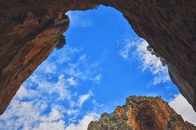 Low angle view of rocky mountains against sky