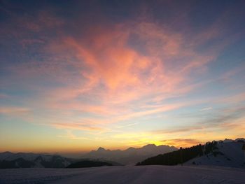 Scenic view of dramatic sky over silhouette landscape