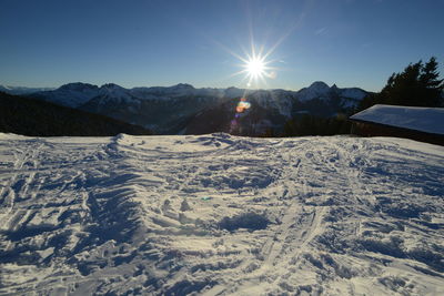 Scenic view of snow covered mountains against sky