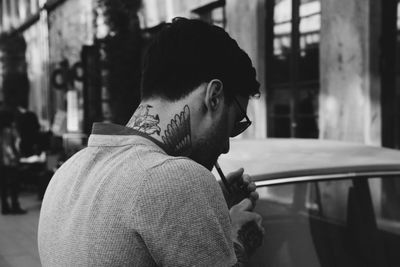 Close-up of young man smoking in city