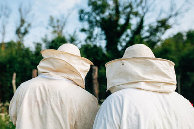 Rear view of beekeepers 