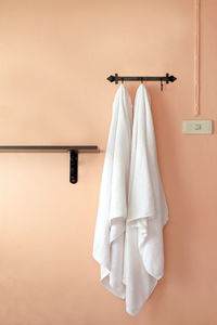 Clothes hanging on white wall at home