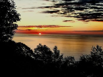 Scenic view of calm sea at sunset