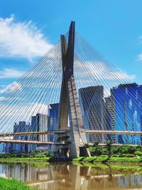 Low angle view of bridge against cloudy sky