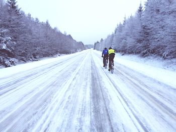 People walking on snow covered road