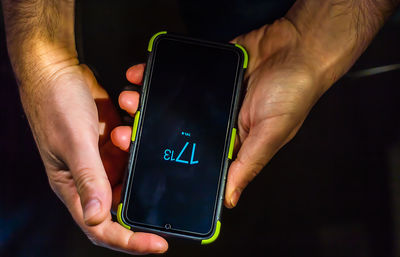 Midsection of man using mobile phone