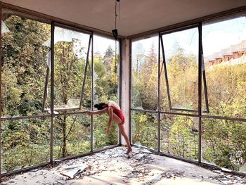 Woman standing by window