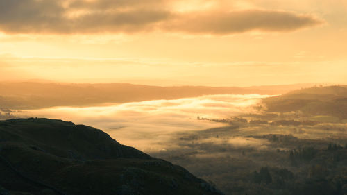 Scenic view of mountains against sky during sunset