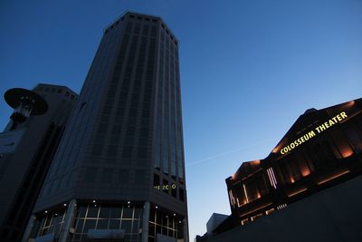 Low angle view of modern buildings against clear blue sky