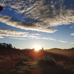 Scenic view of field against sky at sunset