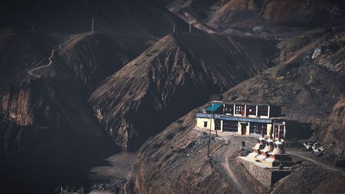 Rock formation amidst buildings and mountains