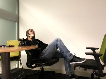 Young man sitting on chair