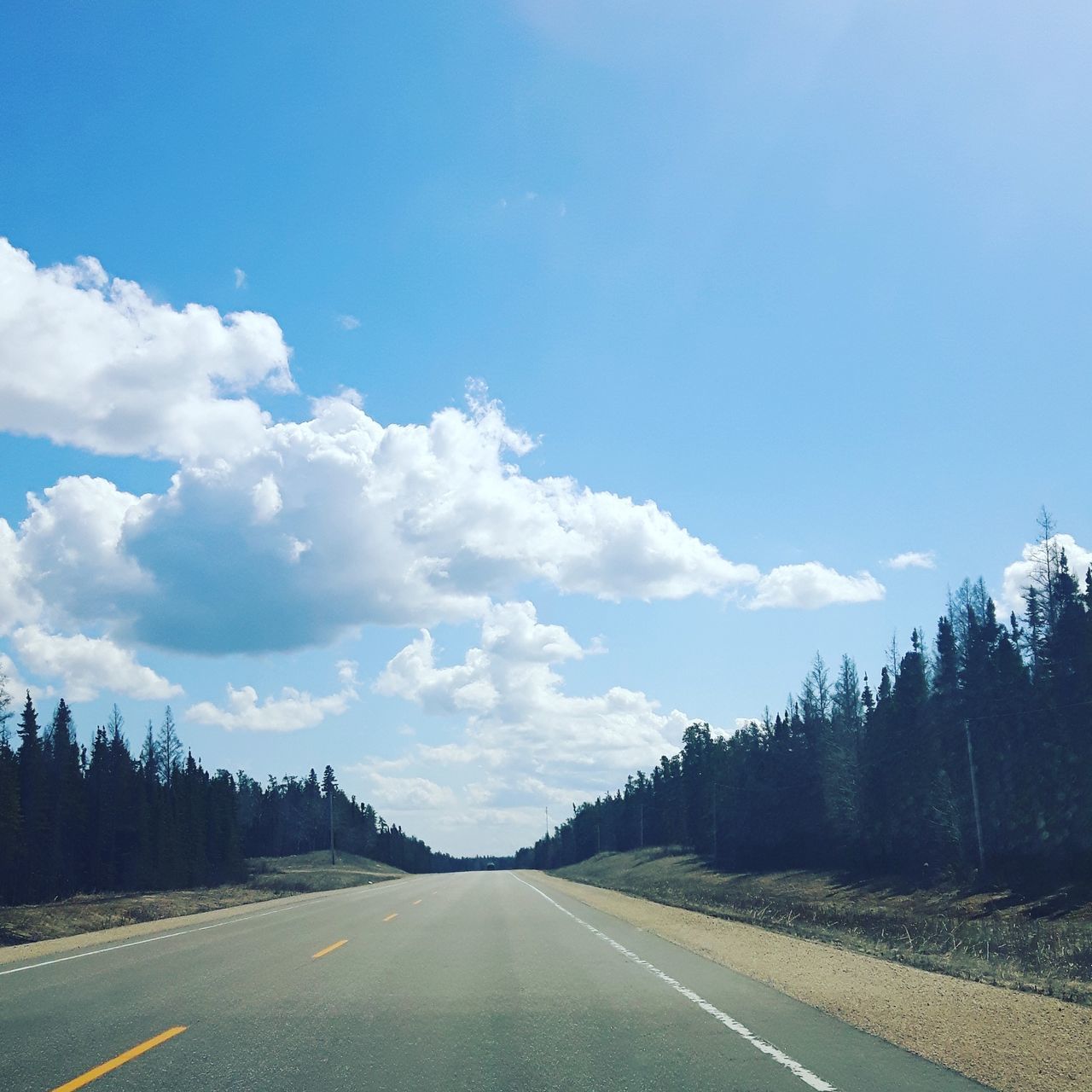 ROAD BY TREES ON MOUNTAIN AGAINST SKY