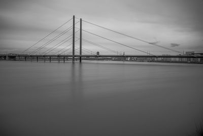 View of suspension bridge against cloudy sky