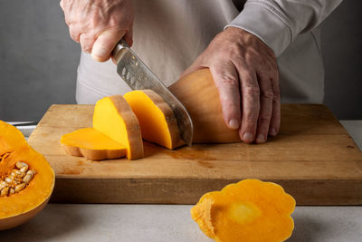 Cropped hands of man preparing food on table