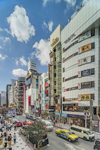 City street by buildings against sky