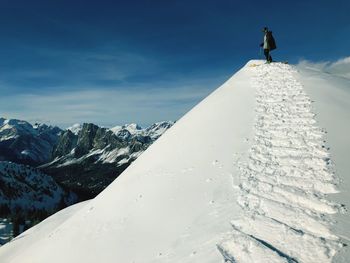 Snow covered mountain range against sky