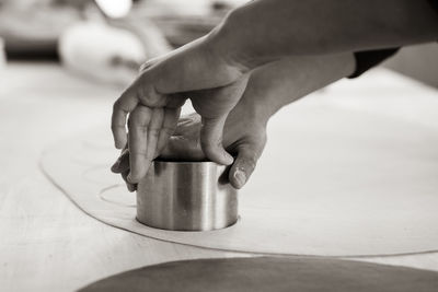 Cropped hand of person preparing food on table