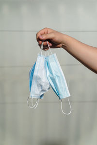 Midsection of woman holding umbrella hanging against wall