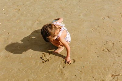 High angle view of girl playing at beach