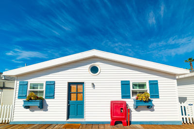 Low angle view of house against blue sky