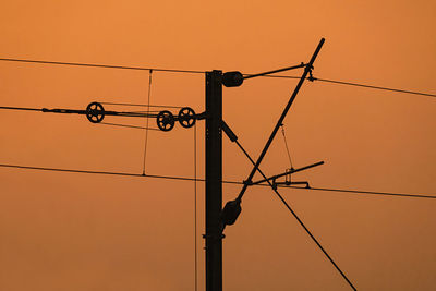 Low angle view of electricity locomotives  traction system in sunset background.