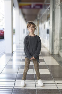 Portrait of girl standing in corridor