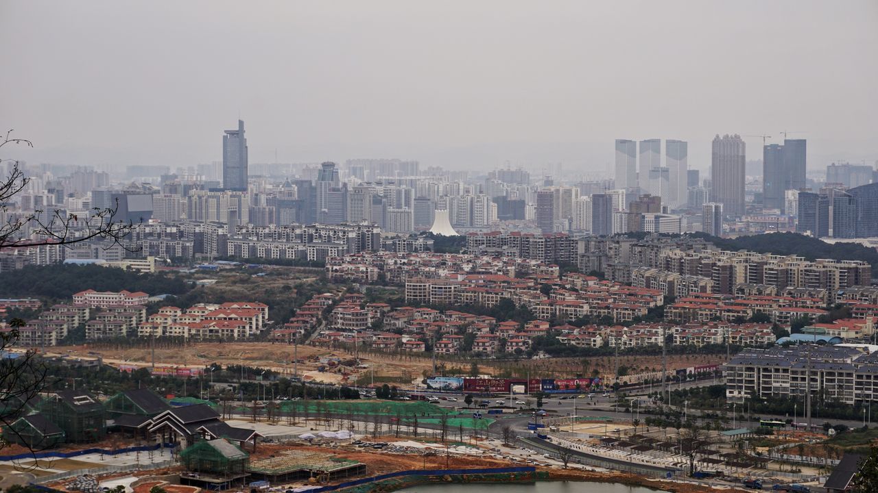 building exterior, architecture, cityscape, built structure, city, high angle view, crowded, skyscraper, residential district, tower, residential building, tall - high, clear sky, city life, urban skyline, sky, residential structure, tree, no people, outdoors