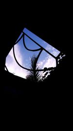 Low angle view of silhouette trees against sky