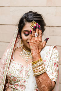 Young beautiful woman looking away showing heena tattoo on her hand