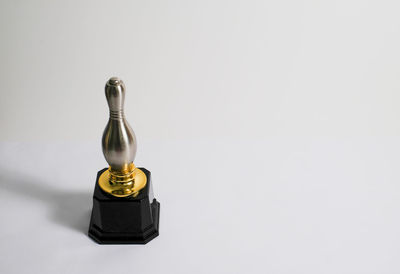 High angle view of bottle on table against white background