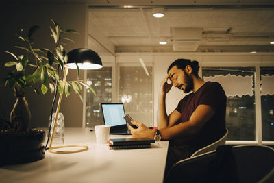 Two people working on table