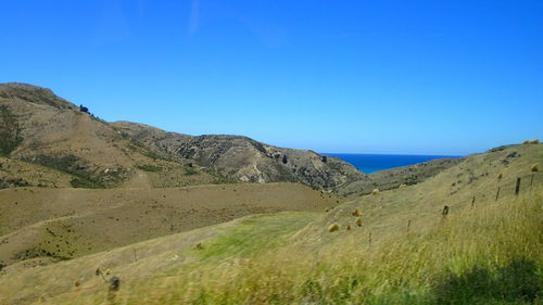 Scenic view of mountains against clear blue sky