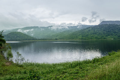 Scenic view of lake and mountains against sky