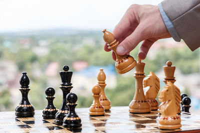 Close-up of hand holding chess pieces