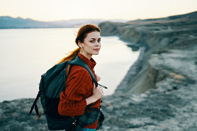 Portrait of young woman standing on mountain