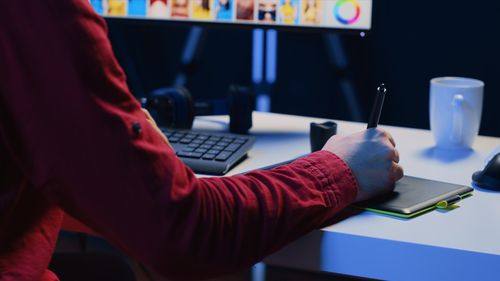 Midsection of woman using laptop