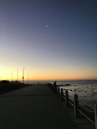 Scenic view of sea against clear sky at sunset