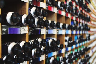 Close-up of bottles in shelves at shop for sale