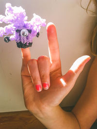 Cropped image of woman wearing craft product on finger