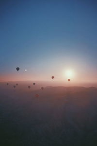 Hot air balloon flying in sky during sunset