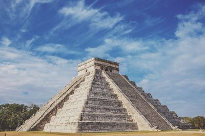 Low angle view of historical building against cloudy sky