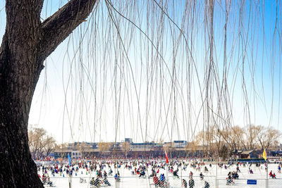 People enjoying on snow covered field