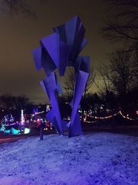 Illuminated city against sky during winter