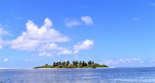 Scenic view of sea against blue sky