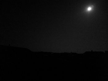 Low angle view of silhouette moon against sky at night