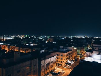High angle view of illuminated buildings in city at night