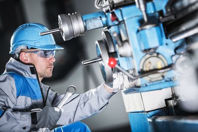 Worker working on machinery in factory